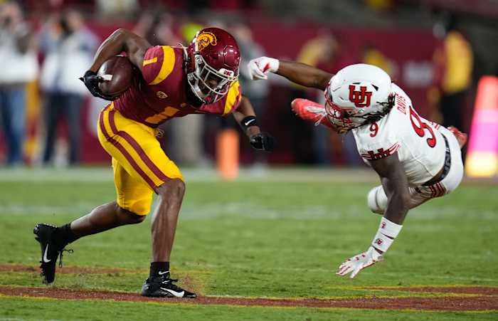 Wide receiver Gary Bryant Jr. stiff arms a defender against the Utah Utes.